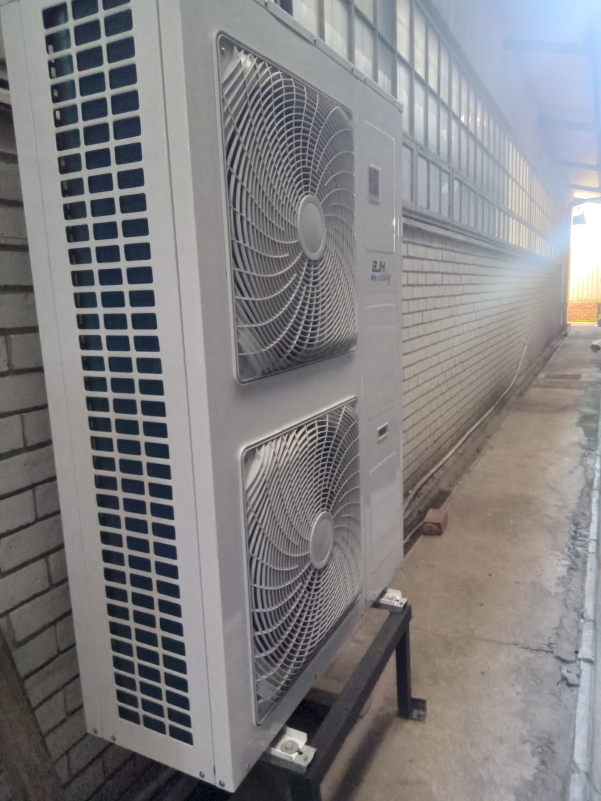 Large dual-fan commercial condensing unit on steel frame