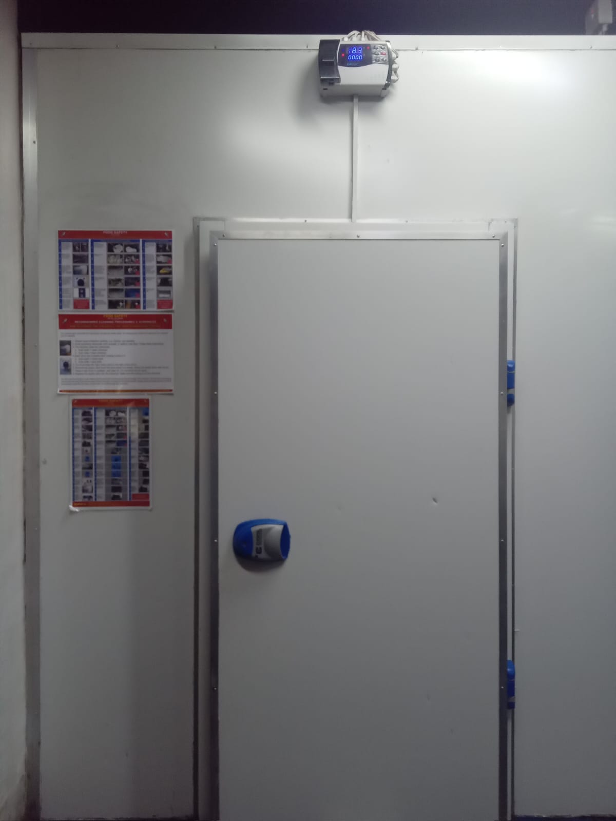 Cold room door with blue handle and temperature monitoring