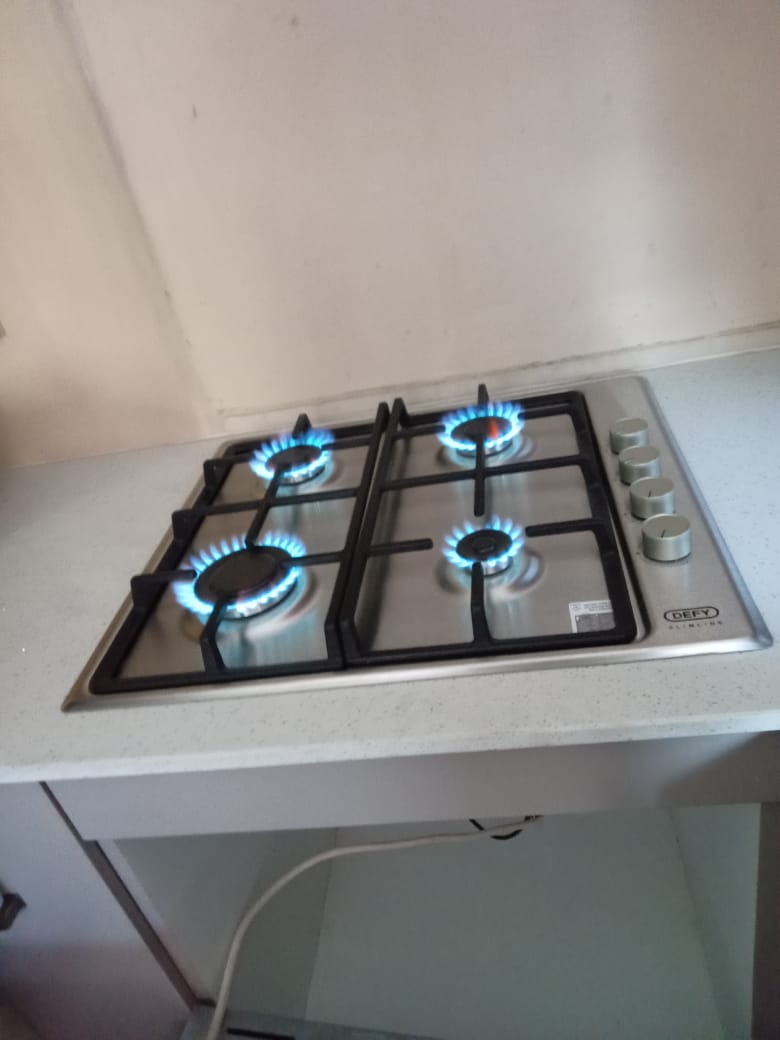 Defy gas hob built into kitchen countertop with all burners operational