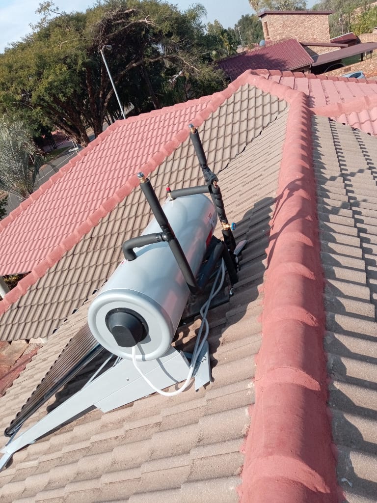 Solar geyser installation on tiled roof ridge