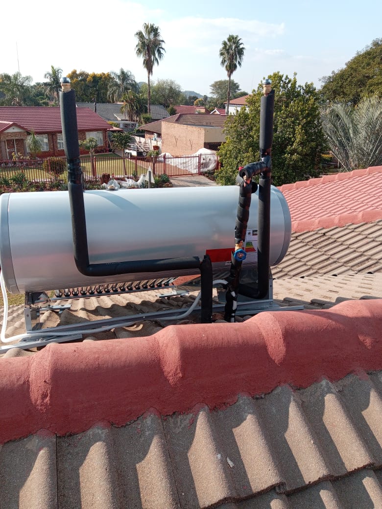 Solar geyser tank and plumbing connections on corrugated roof