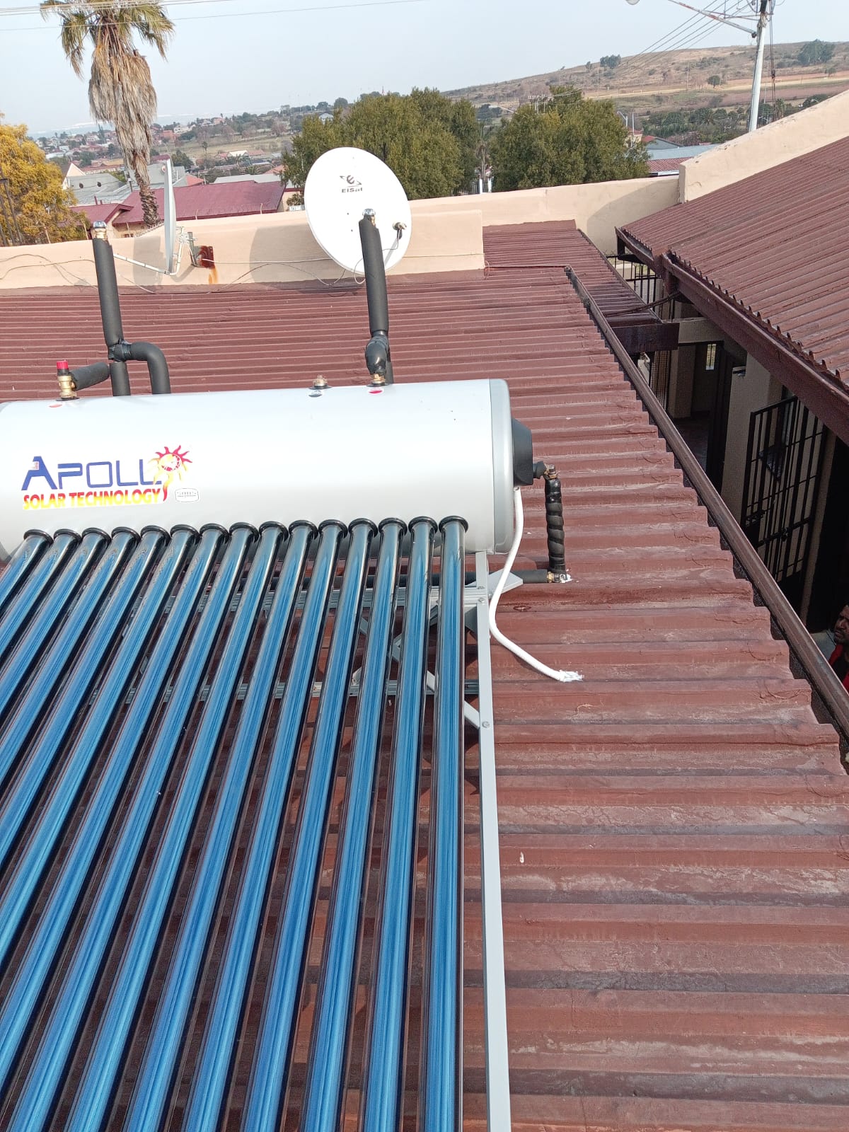 Apollo solar geyser with collector tubes on corrugated iron roof
