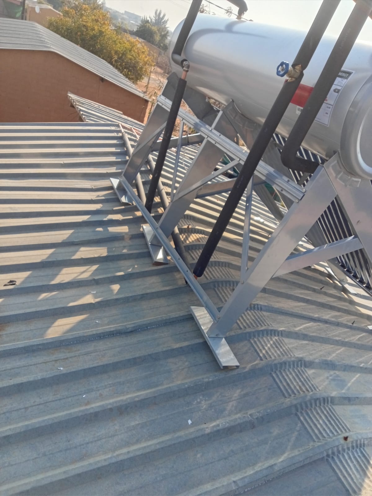 Solar geyser tank mounting frame on corrugated iron roof