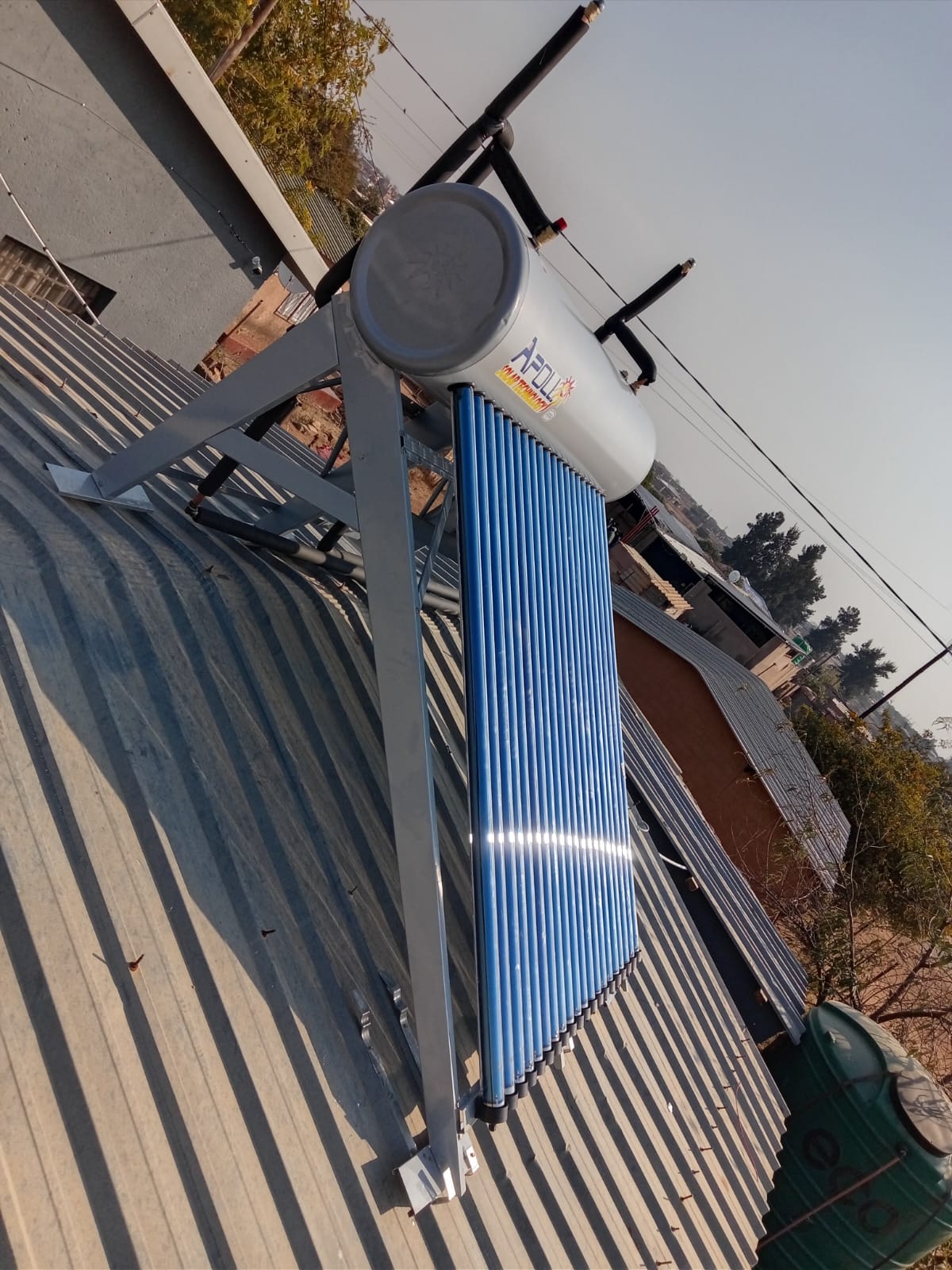 Apollo solar geyser with blue evacuated tubes on corrugated roof