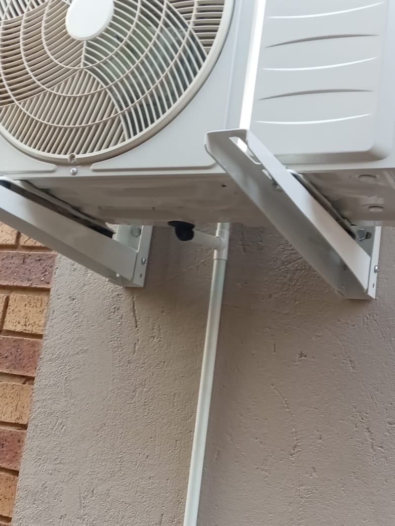 AC outdoor unit wall bracket and trunking close-up detail
