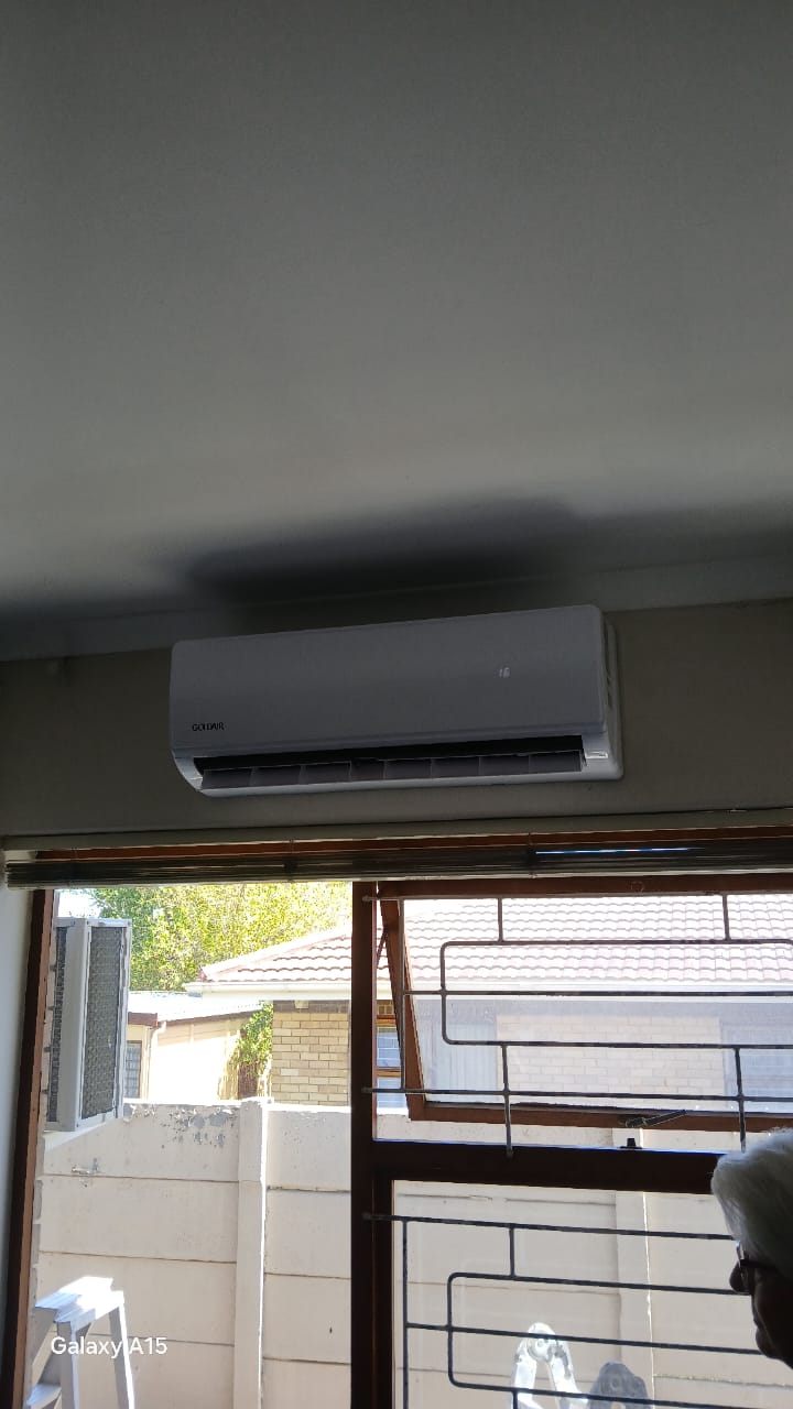 Goldair split AC indoor unit installed above window in living area