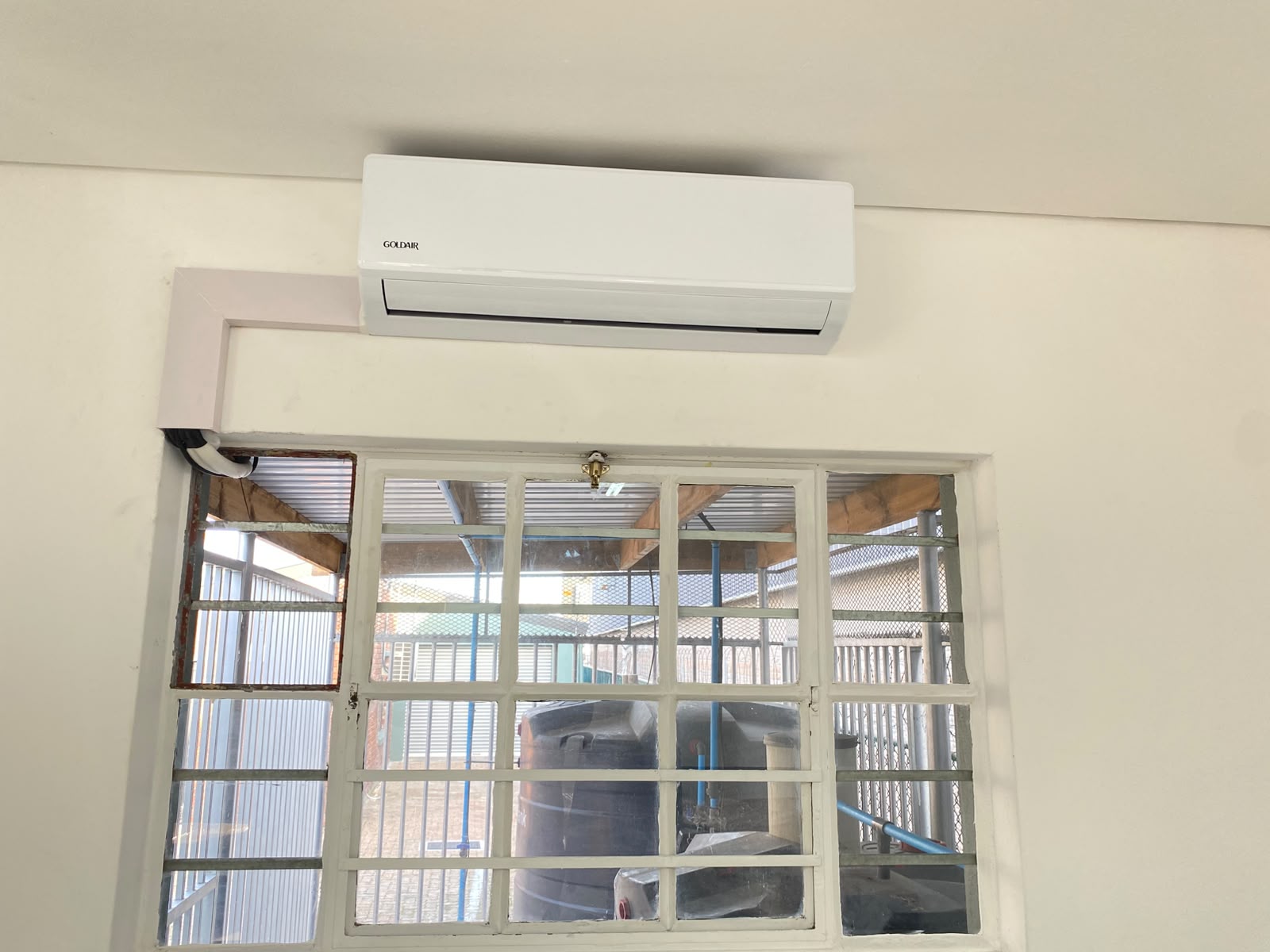 Goldair AC indoor unit with trunking above window