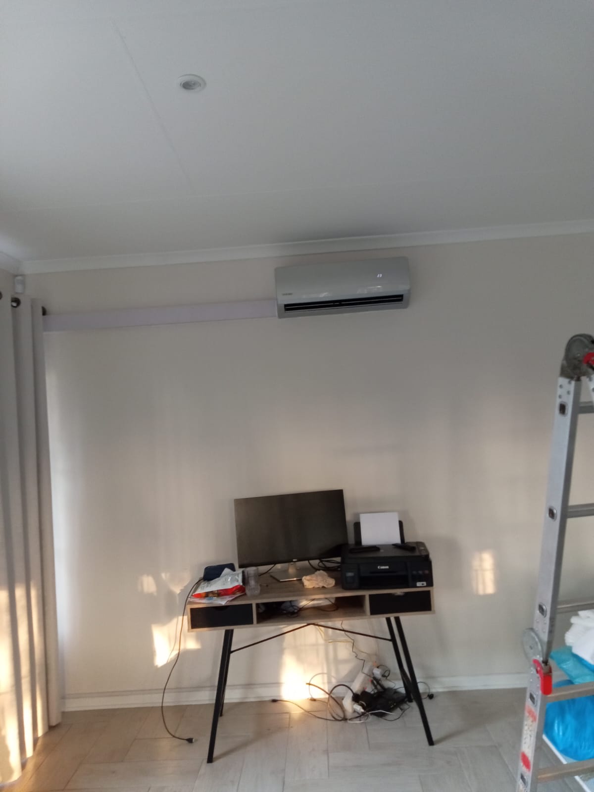 Split AC indoor unit installed in home office above desk
